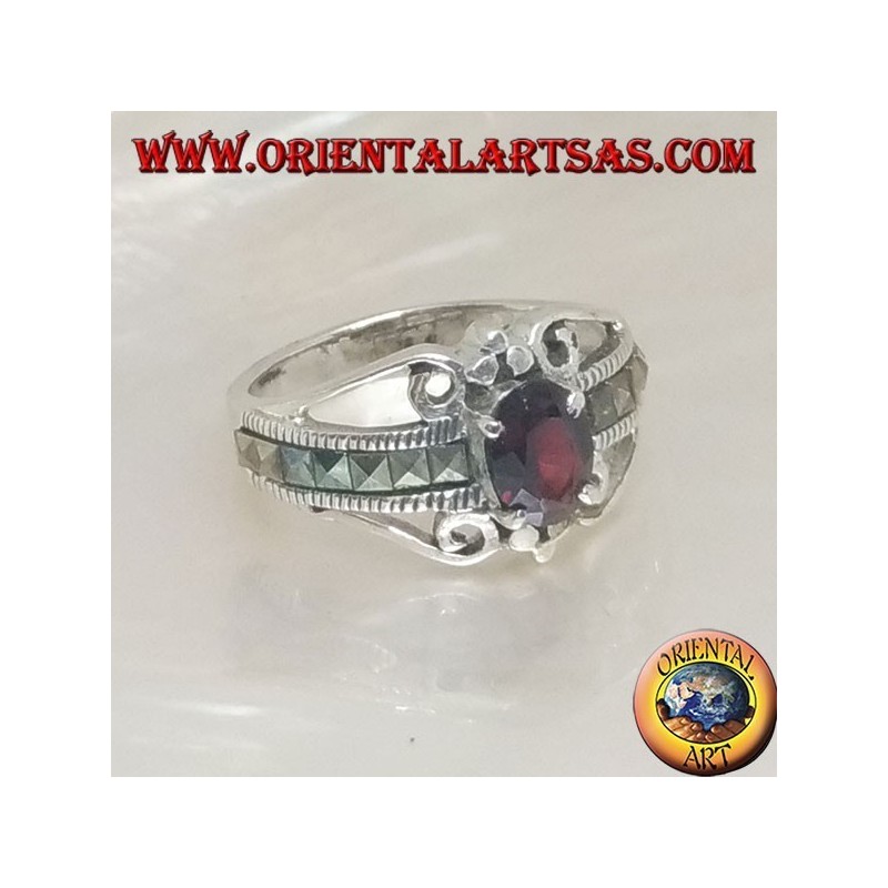 Silver ring set with an oval natural garnet set and a row of square marcasite on the sides