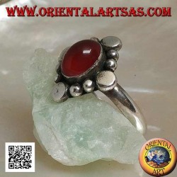 Silver ring with oval cabochon carnelian surrounded by alternating studs and balls