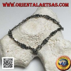 Soft silver bracelet with plaques engraved with bas-relief alternating with rings