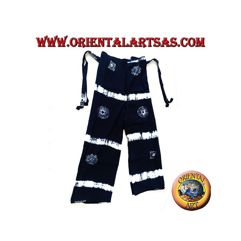 Long blue unisex pantapareo with white designs of horizontal bands and stylized suns