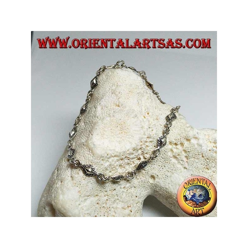 Pulsera de plata suave con placas romboidales con contornos punteados.