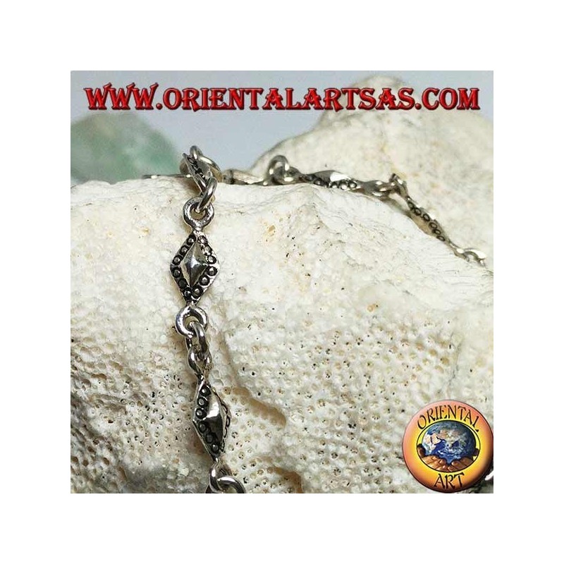 Soft silver bracelet with rhomboid plates with dotted outlines