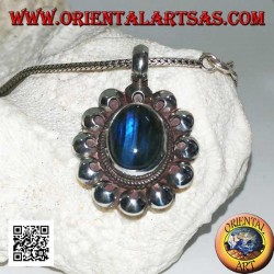 Silver pendant with oval blue fluorescent labradorite cabochon surrounded by perforated discs