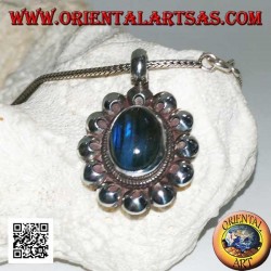 Silver pendant with oval blue fluorescent labradorite cabochon surrounded by perforated discs