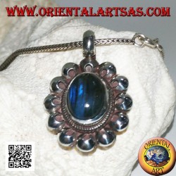 Silver pendant with oval blue fluorescent labradorite cabochon surrounded by perforated discs
