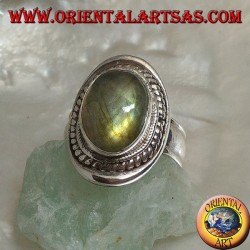 Silver ring with oval cabochon labradorite surrounded by intertwining on a smooth shield
