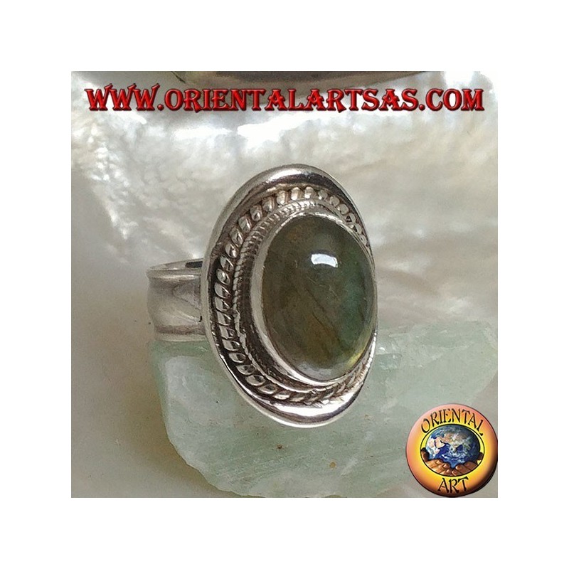 Silver ring with oval cabochon labradorite surrounded by intertwining on a smooth shield