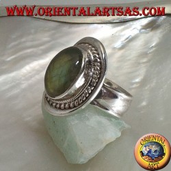 Silver ring with oval cabochon labradorite surrounded by intertwining on a smooth shield