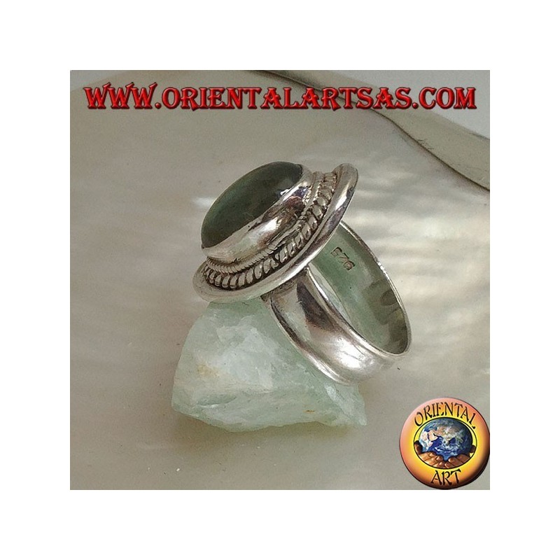 Silver ring with oval cabochon labradorite surrounded by intertwining on a smooth shield