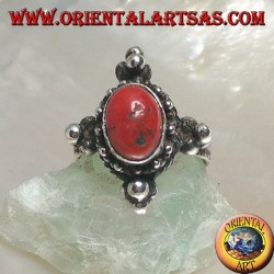 Silver ring with oval Tibetan antique coral surrounded by dots on a Nepalese setting