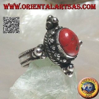 Silver ring with oval Tibetan antique coral surrounded by dots on a Nepalese setting