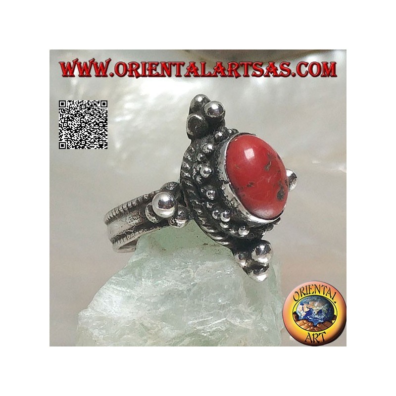 Silver ring with oval Tibetan antique coral surrounded by dots on a Nepalese setting