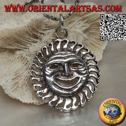 Silver pendant in the shape of the sun with a satirical / ironic face