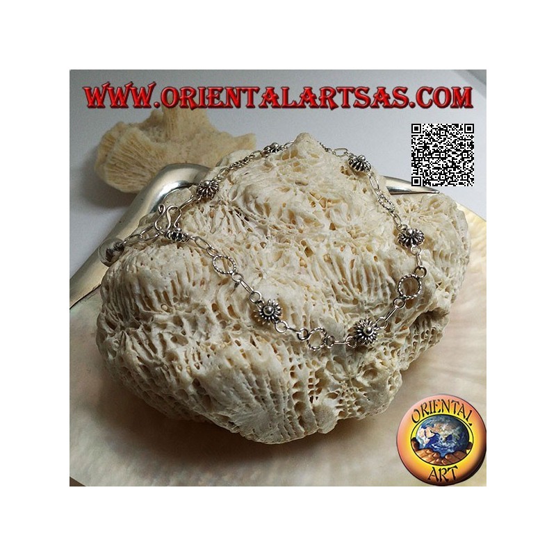 Soft silver bracelet with flowers and alternating circles and final bell