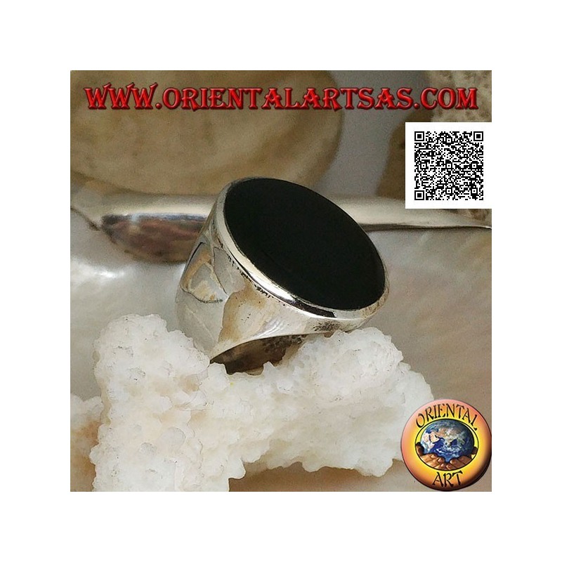 Silver ring with large flat round onyx on a smooth frame slightly concave on the sides