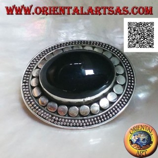 Silver brooch with large oval onyx cabochon surrounded by discs and two strings of dots