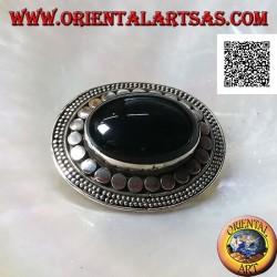 Silver brooch with large oval onyx cabochon surrounded by discs and two strings of dots