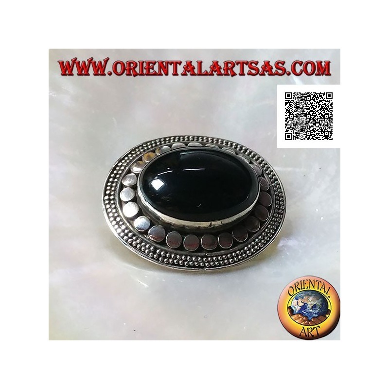 Silver brooch with large oval onyx cabochon surrounded by discs and two strings of dots