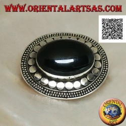 Silver brooch with large oval onyx cabochon surrounded by discs and two strings of dots