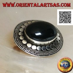 Silver brooch with large oval onyx cabochon surrounded by discs and two strings of dots