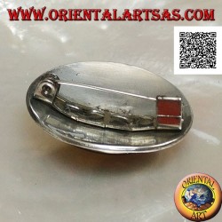 Silver brooch with large oval onyx cabochon surrounded by discs and two strings of dots