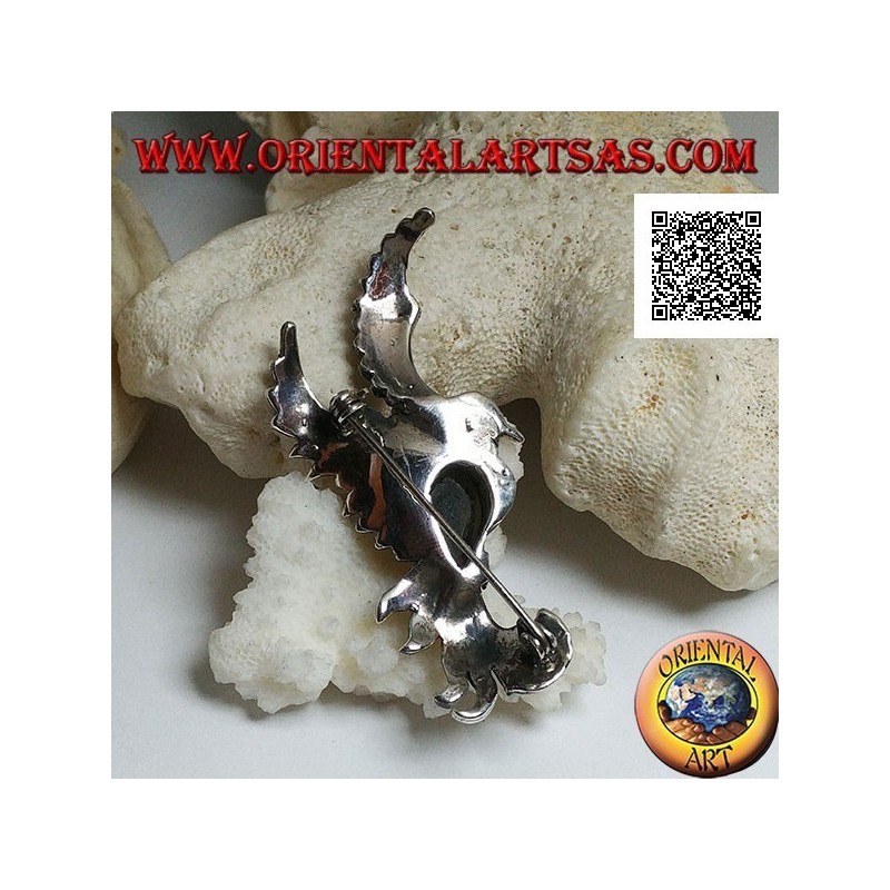Broche de plata con forma de fénix en vuelo de perfil tachonado de marcasita y con una gota de ónix