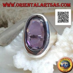 Silver ring with oval faceted amethyst on a smooth asymmetrical oval frame