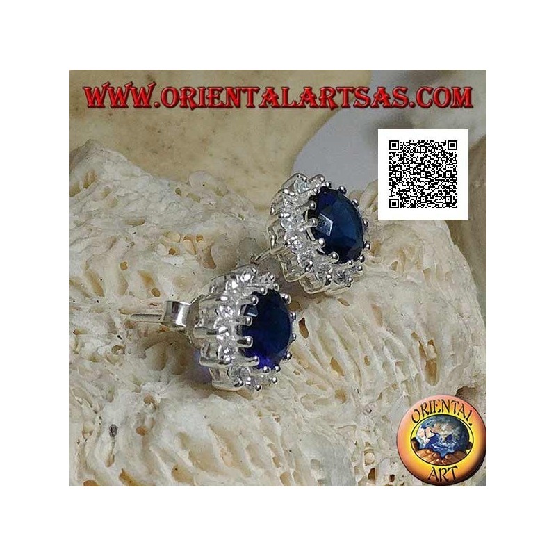 Silver earrings with round sapphire-colored zircon surrounded by white zircons