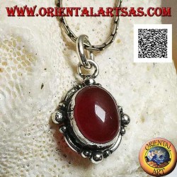 Silver pendant with oval cabochon carnelian surrounded by silver with a ball on the four cardinal points
