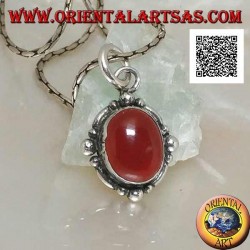 Silver pendant with oval cabochon carnelian surrounded by silver with a ball on the four cardinal points