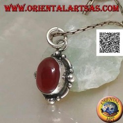 Silver pendant with oval cabochon carnelian surrounded by silver with a ball on the four cardinal points