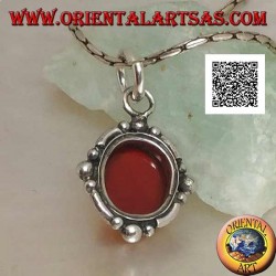 Silver pendant with oval cabochon carnelian surrounded by silver with a ball on the four cardinal points