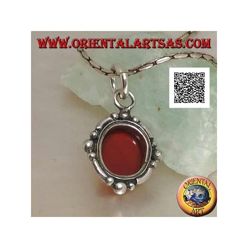 Silver pendant with oval cabochon carnelian surrounded by silver with a ball on the four cardinal points