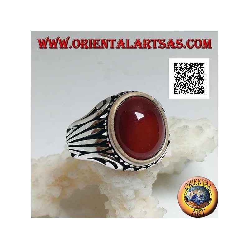 Silver ring with oval cabochon carnelian surrounded by dots and stripes engraved on the sides