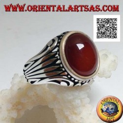 Silver ring with oval cabochon carnelian surrounded by dots and stripes engraved on the sides