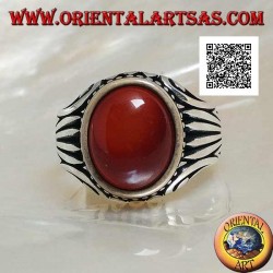 Silver ring with oval cabochon carnelian surrounded by dots and stripes engraved on the sides