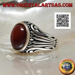 Silver ring with oval cabochon carnelian surrounded by dots and stripes engraved on the sides