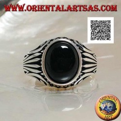 Silver ring with oval onyx cabochon surrounded by dots and stripes engraved on the sides