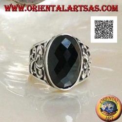 Silver ring with oval faceted onyx and openwork decoration on the sides