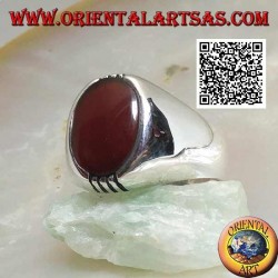 Silver ring with oval carnelian on a smooth frame and 4 rows above and below