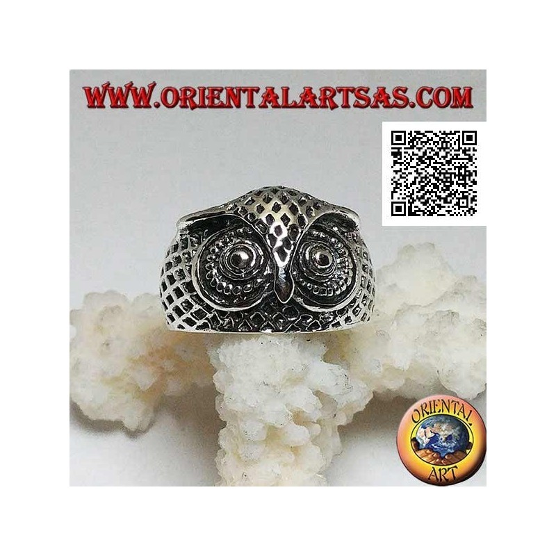 Silver ring in the shape of an owl head with eyes decorated with carvings