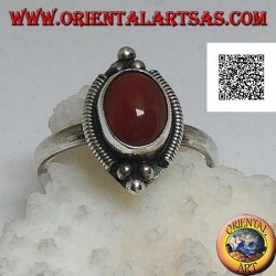 Silver ring with oval cabochon carnelian surrounded by stripes and trio of balls above and below