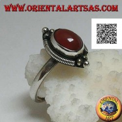 Silver ring with oval cabochon carnelian surrounded by stripes and trio of balls above and below