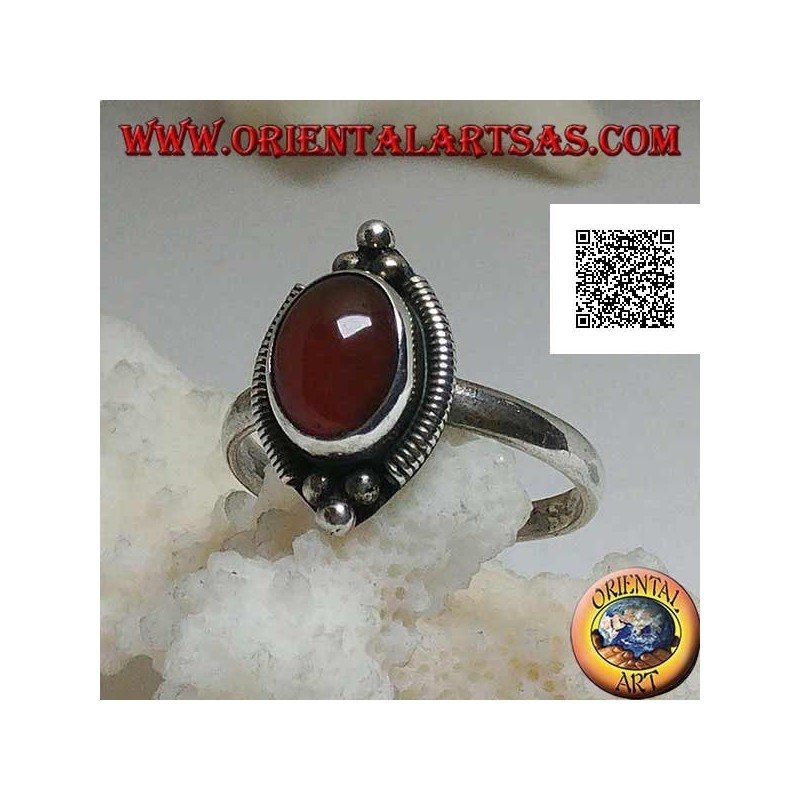 Silver ring with oval cabochon carnelian surrounded by stripes and trio of balls above and below