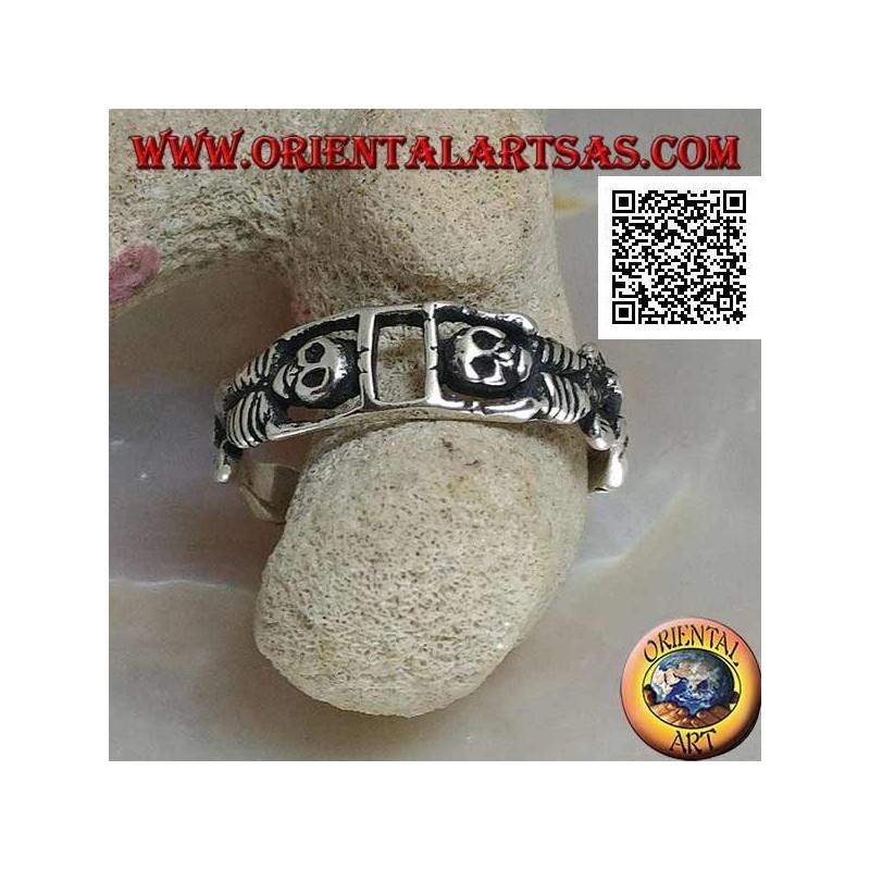 Silver ring composed of two stretched skeletons joined by the arms
