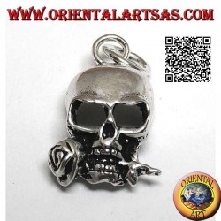 Silver pendant in the shape of a skull with a rose between the teeth
