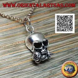 Silver pendant in the shape of a skull with a rose between the teeth