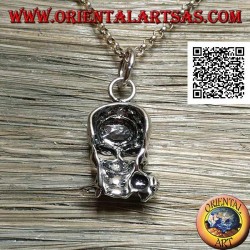 Silver pendant in the shape of a skull with a rose between the teeth