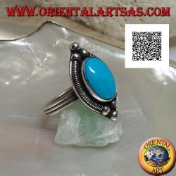 Bague en argent avec cabochon ovale turquoise entouré d'entrelacs sur une plaque et trois boules dessus et dessous