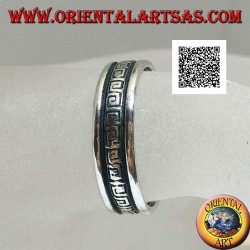 Silver wedding ring with a series of spiral labyrinths engraved in the central part